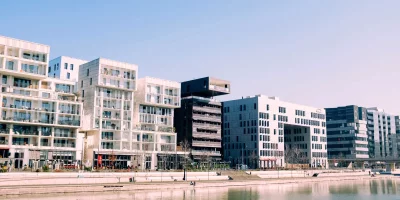Immeubles modernes au bord de l'eau sous un ciel bleu — investissement-locatif