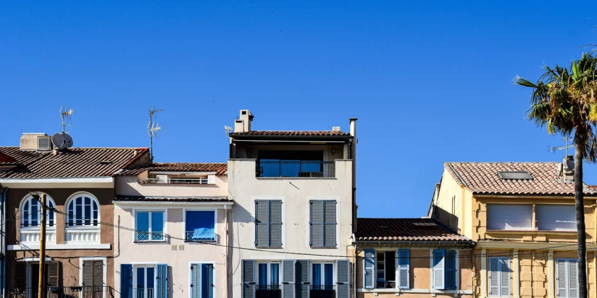 Immeubles colorés avec balcons et ciel bleu — taxe foncière 2026